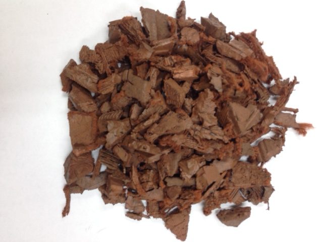 pile of light brown colored rubber nugget mulch